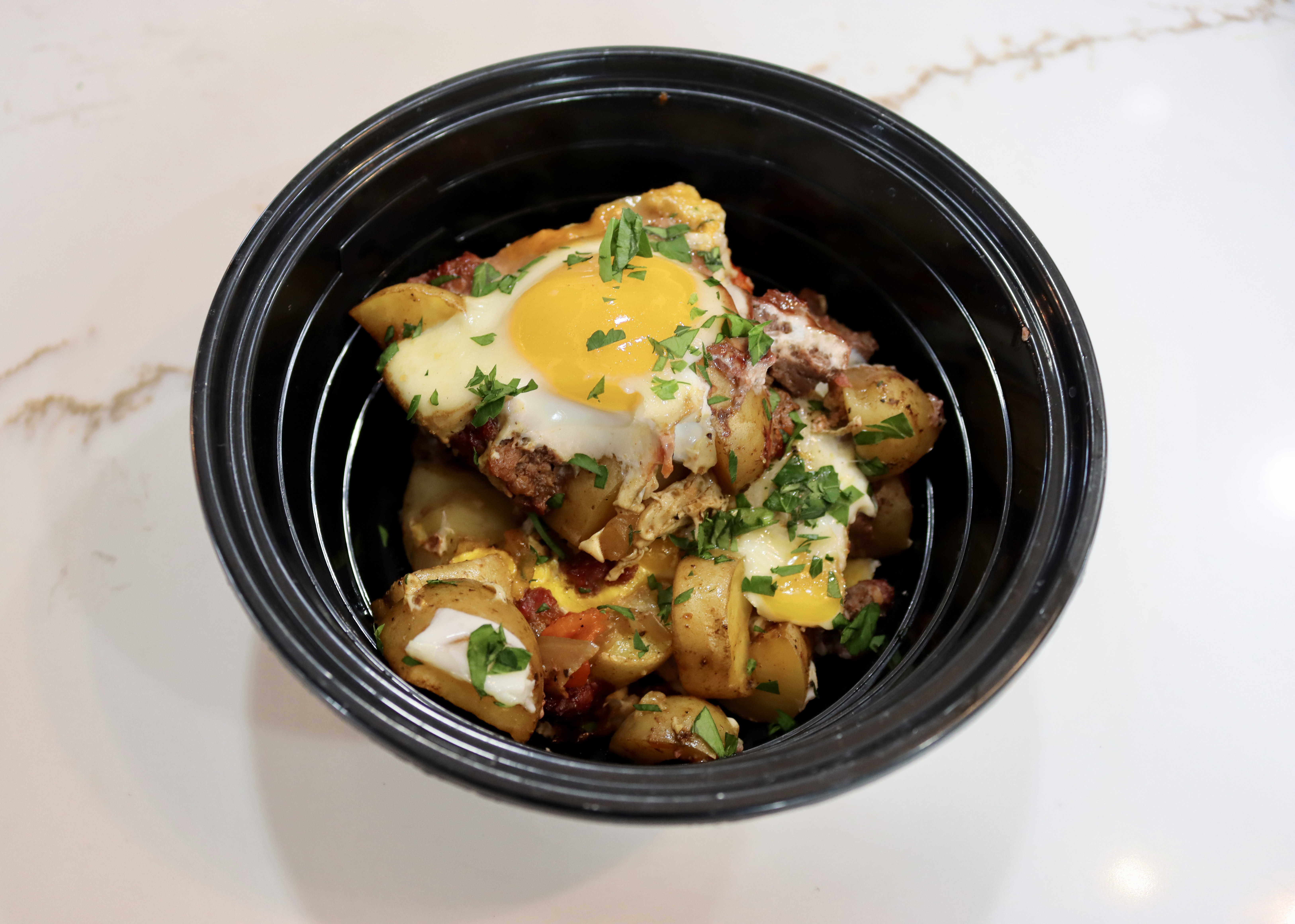 grilled breakfast hash in microwavable meal prep bowl on counter