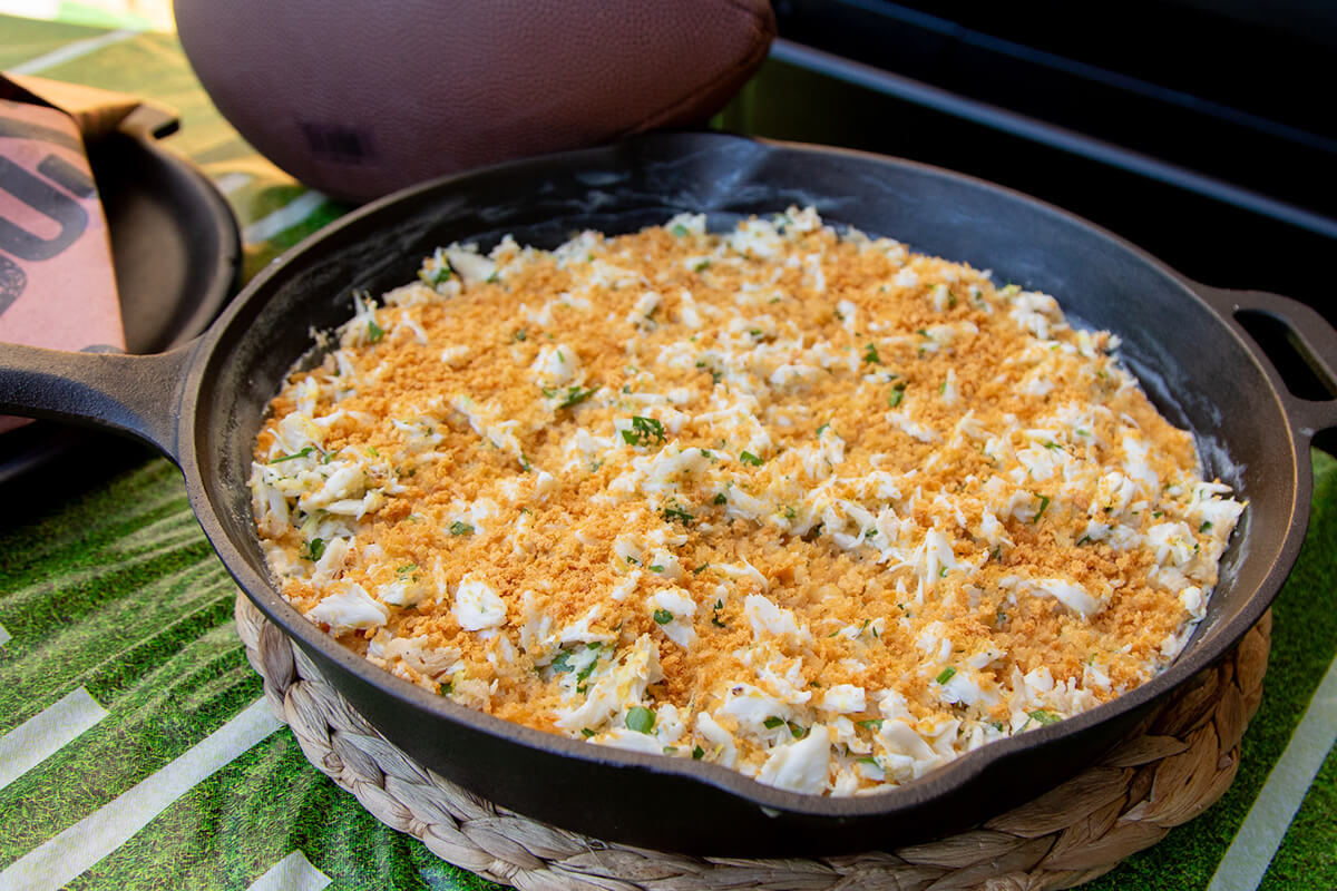 smoked crab dip served in cast iron with toasted pita chips