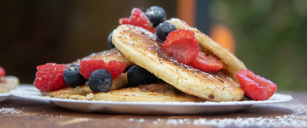 Yummy pancakes with berries and powered sugar on top