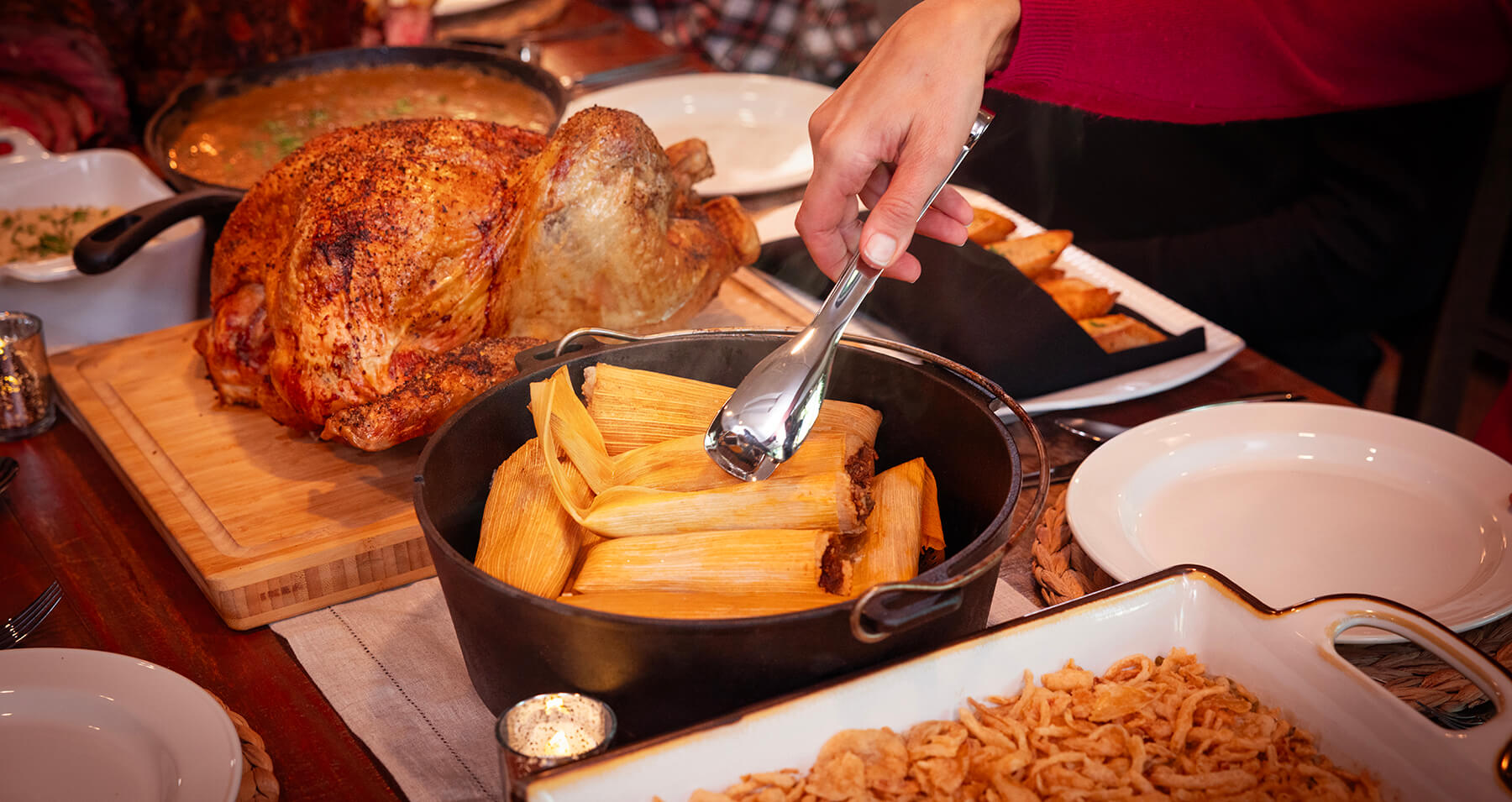 steamed and smoked tamales in dutch oven on holiday dinner table